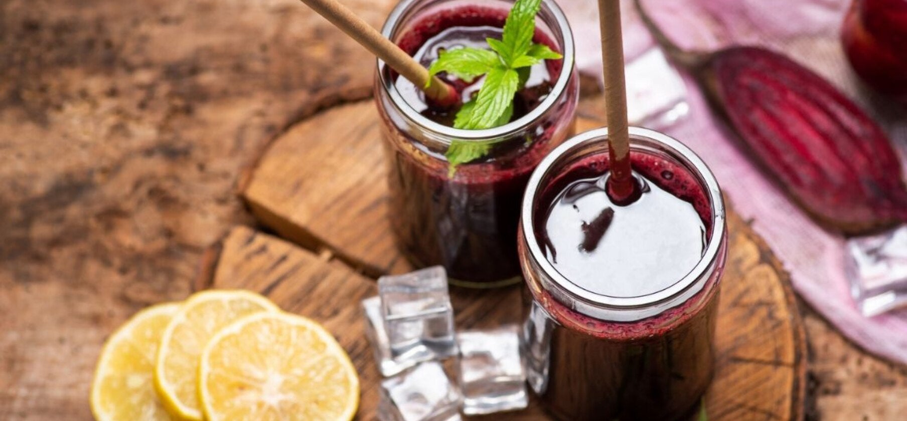 Two jars of juice with lemon slices and straws - juice with collagen