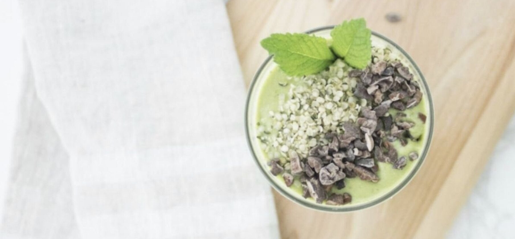 A nutritious collagen smoothie displayed in a clear glass, featuring a rich color